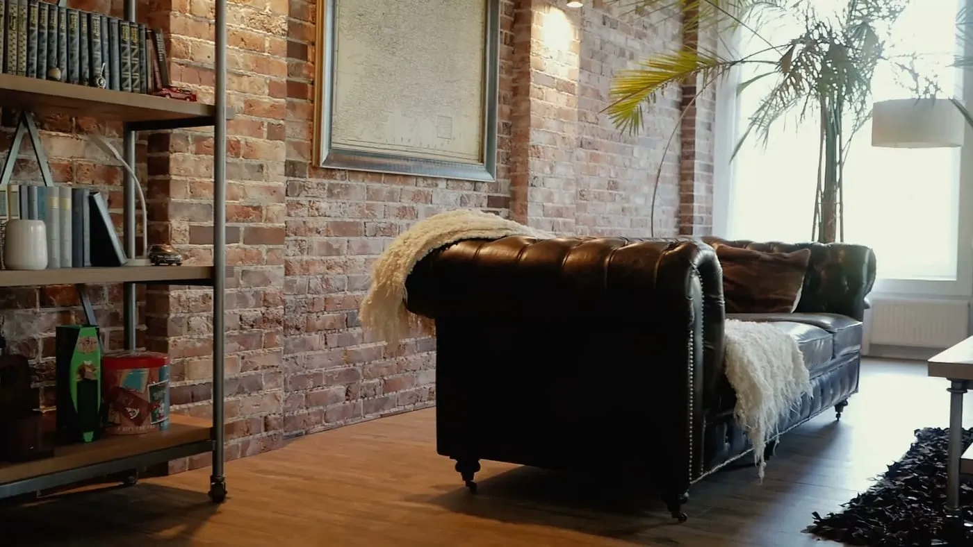 Two layered rugs in a small UK living room, a jute base rug under a smaller patterned rug